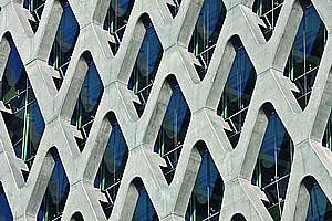 Filigree reinforced concrete net shapes and supports office tower