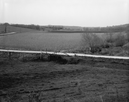 Eureka Bridge, Castalia, Iowa:Distant view, showing bridge in context with agricultural (pastures and cornfields) setting; looking southeast.