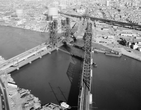 Aerial "barrel" shot of the PATH transit system bridge, looking southeast towards Jersey City. To the left are the Newark turnpike and the Conrail bridge. The Pulaski Skyway is in the background to the right