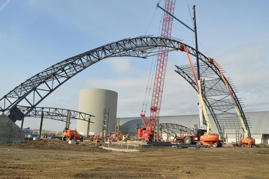 DAYTON, Ohio – Construction crews attach the keystone into place between the steel archways. The 224,000 square foot building, which is scheduled to open to the public in 2016, is being privately financed by the Air Force Museum Foundation, a non-profit organization chartered to assist in the development and expansion of the museum's facilities