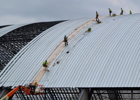 Dayton, Ohio – Crews working on the roof installation for the museum's fourth building on June 12, 2015. The 224,000 square foot building, which is scheduled to open to the public in 2016, is being privately financed by the Air Force Museum Foundation, a non-profit organization chartered to assist in the development and expansion of the museum's facilities