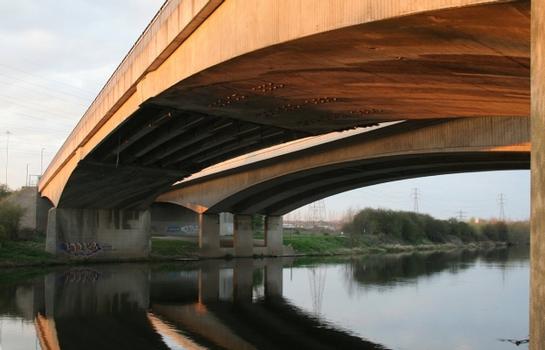 View of the two bridges. The original bridge is on the right. The view shows the different structural form of the two bridges, although the profile of the arch is almost identical. The original is of box girder construction in true arch form. The later bridge is in the form of cantilever piers with a separate supported central flat span section. This results in a flattening of the profile of the arch compared with the original bridge.