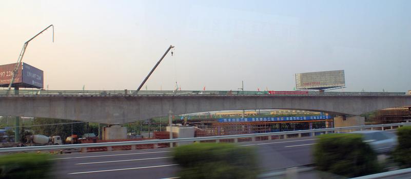 Structures of the Beijing-Shanghai high-speed rail line under construction along the highway between Nanjing and Shanghai