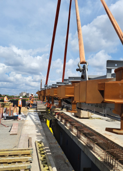 Lifting a large expansion joint into position in August 2023