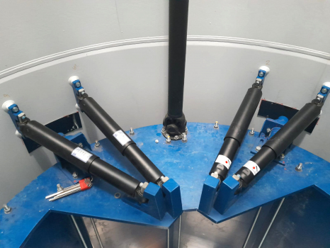 Hydraulic dampers fitted inside the flagpole and connected to the blue damper mass, in order to absorb and limit its movements