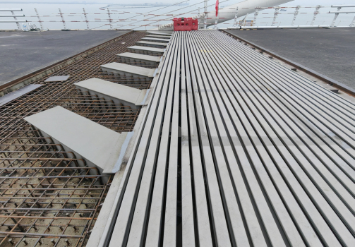 The expansion joint in place ready to be encased in con-crete. The boxes containing the swivel joists are visible on the left