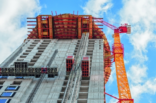 For constructing the barrel-shaped section of the Henninger Turm, a cantilevered working and scaffolding platform up to 8 m long was formed at a height of 100 m on the basis of rentable standard system components in 100 m height.