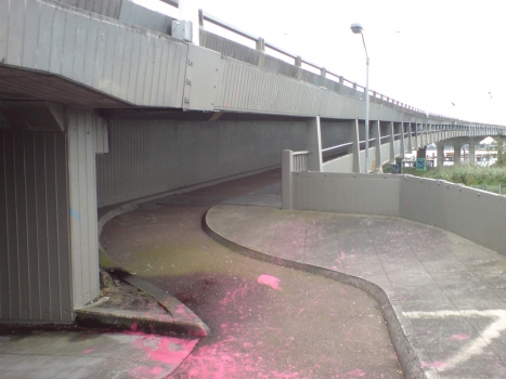 The cycleway under Mangere Bridge in Auckland City, New Zealand. The cycleway is little used, for it is covered in graffiti, and there is a more pleasant bridge running in parallel next to it.