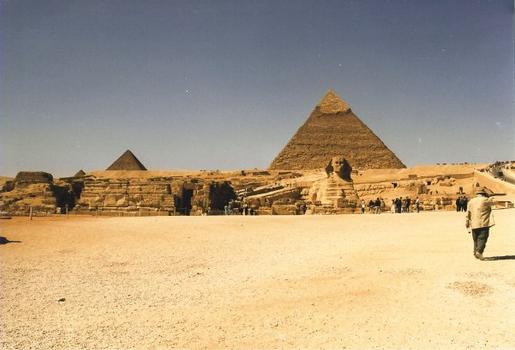 Sphinx in front of the Pyramid of Chefren. Pyramid of Mycerinus to the left