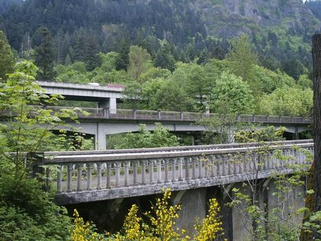 Moffett Creek Bridge and adjacent Interstate 84 bridges (c.1950 and 1969) overshadowed by the cliffs of the Columbia River Gorge