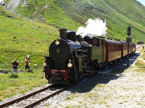 Steam train at Muttbach-Belvedere Station, in front of Furka Tunnel western portal