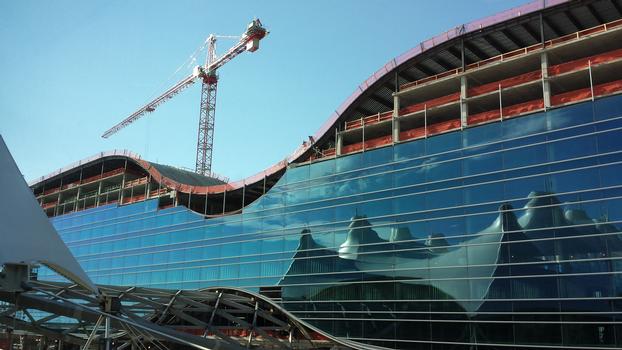 The Westin at Denver International Airport - Construction progress. The roof of the Jeppesen Terminal is reflected in the glass facade