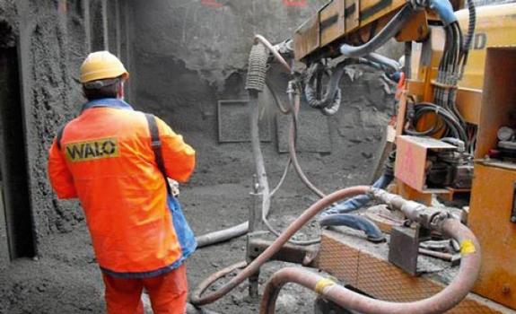 Production of a steel fibre shotcrete test specimen (the formwork units can be seen in the background)
: Production of a steel fibre shotcrete test specimen (the formwork units can be seen in the background)