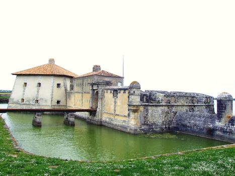 Fort Lupin - Le réduit, la porte, l'échauguette, le fossé rempli d'eau, son batardeau avec dame et le début de la batterie semi-circulaire à 22 embrasures avec réduit de gorge