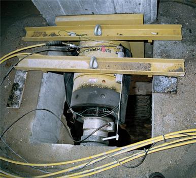 Prado: Enerpac 500 ton double-acting lock nut jack with positioning sensor and Class A load cell used to keep the basement walls of the Prado extension in position