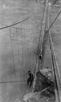 Kaibab Trail Suspension Bridge : 
Rigger astride 7/8' cable making hitch to haul up main cable 
(HAER, ARIZ,3-GRACAN,3-16)
