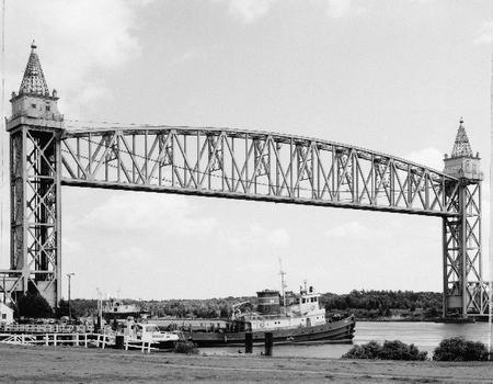 LONG GENERAL VIEW, WEST SIDE OF BRIDGE FROM NORTHWEST SHORE OF CANAL, VIEW TO NORTH - Cape Cod Canal Lift Bridge, Spanning Cape Cod Canal, Buzzards Bay, Barnstable County, MA (HAER MASS,1-BUZBA,1–2)