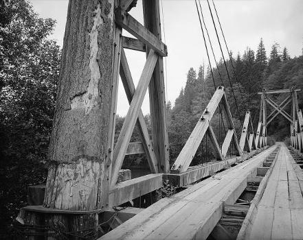 Chow Chow Bridge: Three-quarter view of bridge showing tower, king post trusses, and suspension cables (HAER, WASH,14-TAH.V,1-4)
