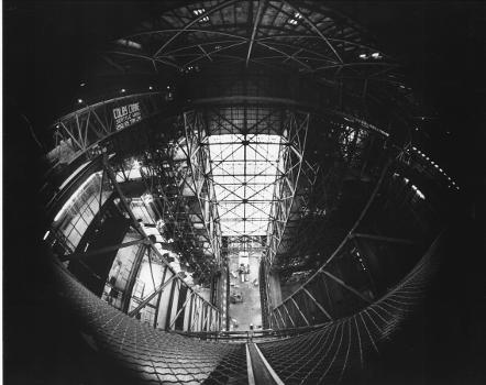Vehicle Assembly Building (VAB): A fisheye lens gives a strange view from high in the Vehicle Assembly Building at the Kennedy Space Center where the 250-ton bridge cranes operate. The cranes are used to move about the three stages of the 363-foot-tall Saturn V and to ultimately stack them into one vehicle.