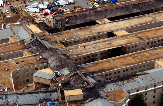 An aerial view showing the level of the destruction at the Pentagon caused by a terrorist attack. The morning of September 11th, in an attempt to frighten the American people, five members of Al-Qaida, a terrorist group of fundamentalist Muslims, hijacked American Airlines Flight 77, then deliberately impacted the Pentagon killing all 64 passengers onboard and 125 people on the ground. The impact destroyed or damaged four of the five rings in that section of the building. Firefighters fought the fire through the night. The Pentagon was the third target by four hijacked aircraft, the twin towers of the World Trade Center (WTC) were the other targets, and one unknown when the passengers brought the aircraft down in a Pennsylvania field