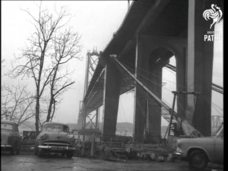 New Forth Bridge Under Construction (1963):Firth of Forth, Scotland. 
Documentation and programme on file from The Scottish National Institution for War-Blinded. 
VS. From car travelling along Forth Bridge road, rain on the windscreen makes viewing difficult. VS. Showing the near completed new Forth Road Bridge, only a centre section remains to be fitted. Construction engineers are seen walking about but not working for it is windy and rain is lashing down. LV. The Forth Bridge. VS. In the Scottish National Institute for War-Blinded, a blind man sits at a machine, he is engaged in making plastic plugs which are used in the construction of the new bridge. This place is in Wilkieston.
(Orig. Neg.)
FILM ID:3096.17
A VIDEO FROM BRITISH PATHÉ. EXPLORE OUR ONLINE CHANNEL, BRITISH PATHÉ TV. IT'S FULL OF GREAT DOCUMENTARIES, FASCINATING INTERVIEWS, AND CLASSIC MOVIES. http://www.britishpathe.tv/
FOR LICENSING ENQUIRIES VISIT http://www.britishpathe.com/
British Pathé also represents the Reuters historical collection, which includes more than 136,000 items from the news agencies Gaumont Graphic (1910-1932), Empire News Bulletin (1926-1930), British Paramount (1931-1957), and Gaumont British (1934-1959), as well as Visnews content from 1957 to the end of 1984. All footage can be viewed on the British Pathé website. https://www.britishpathe.com/