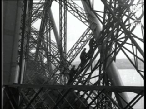 Men Of The Forth Bridge (1930):The Forth Bridge, Strathclyde, Scotland.
Full titles read: "THE MEN OF THE FORTH BRIDGE - Working on a job that never ends - keeping order the great Spans of the mighty Forth Bridge."
Good L/S of the massive bridge. The Scottish narrator informs us that the it takes three years to paint the bridge and "50 tonnes of paint to do it."
L/S's of workmen climbing up the cantilevers of the bridge. A steam locomotive and train pass beneath them. Several shots of men painting the metal work. L/S of man climbing down rope ladder.
Intertitle reads: "Over 350 feet above a wet and watery grave (if you slipped) - day in and out, these High Society Fellows are on the job."
L/S of man wearing flat cap hammering one of the metal supports. Another man climbs past him and jokes - "I hope I don't slip !"
Note; apparently the Forth Bridge is not actually in Strathclyde, but links Fife with the Lothians by spanning the River Forth.
FILM ID:1012.23
A VIDEO FROM BRITISH PATHÉ. EXPLORE OUR ONLINE CHANNEL, BRITISH PATHÉ TV. IT'S FULL OF GREAT DOCUMENTARIES, FASCINATING INTERVIEWS, AND CLASSIC MOVIES. http://www.britishpathe.tv/
FOR LICENSING ENQUIRIES VISIT http://www.britishpathe.com/
British Pathé also represents the Reuters historical collection, which includes more than 136,000 items from the news agencies Gaumont Graphic (1910-1932), Empire News Bulletin (1926-1930), British Paramount (1931-1957), and Gaumont British (1934-1959), as well as Visnews content from 1957 to the end of 1984. All footage can be viewed on the British Pathé website. https://www.britishpathe.com/