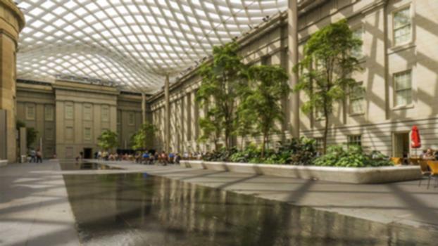 National Portrait Gallery - Kogod Courtyard:The Robert and Arlene Kogod Courtyard is a part of the building housing the Smithsonian's National Portrait Gallery and the Smithsonian American Art Museum, formerly the Patent Office Building where Walt Whitman once worked as a clerk.
The light–filled Kogod Courtyard is a major gathering place in Washington's Chinatown neighborhood, unusual for its distance from the National Mall as a Smithsonian Institution building. It is a welcoming space downtown, as well as a public venue for the museums' performances, lectures and special events.
The roof is a wavy glass–and–steel structure that appears to float over the courtyard, letting in natural light but protecting visitors from the elements. The double–glazed glass panels are set in a grid completely supported by eight aluminum–clad columns located around the perimeter of the courtyard so that the weight of the roof does not affect the National Historic Landmark building.
The courtyard, which can be viewed from the museums' galleries, accommodates an array of activities, including art–making programs, children's activities, concerts and performances, and is a favored lunching place for both tourists and the many workers in the neighboring Gallery Place office buildings.
Captured with a Sony a6000 camera and Sony SEL1018 lens. Audio recorded with a Sony PCM-M10.