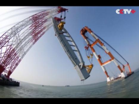 Record-breaking Head Tower Hoisted on Hong Kong-Zhuhai-Macao Bridge : The first head tower of the Hong Kong-Zhuhai-Macao Bridge (HZMB) was successfully hoisted on Sunday, breaking the world record for the largest tower. 
The 3000-ton head tower, measuring 105 meters high, was steadily lifted onto its base during a 10-hour operation. 
"It is the first time such a large head tower has been hoisted anywhere in the world," said Yang Shaoxi, vice general manager of Wuchang Shipbuilding Industry Group, the company in charge of the tower project. 
Yang said that the project marks a great leap forward for China in terms of bridge construction. 
"The remaining two towers will be hoisted at the end of September or in early October. We will safely complete the operation with high quality," he added. 
The bridge, situated in Lingdingyang in the Pearl River Estuary, is a mega sea crossing linking the Hong Kong Special Administrative Region, the city of Zhuhai in Guangdong Province, and Macao Special Administrative Region.
More on: http://newscontent.cctv.com/NewJsp/news.jsp?fileId=312438
Subscribe us on Youtube: https://www.youtube.com/channel/UCmv5DbNpxH8X2eQxJBqEjKQ
CCTV+ official website: http://newscontent.cctv.com/
LinkedIn: https://www.linkedin.com/company/cctv-news-content?
Facebook: https://www.facebook.com/pages/CCTV/756877521031964
Twitter: https://twitter.com/NewsContentPLUS