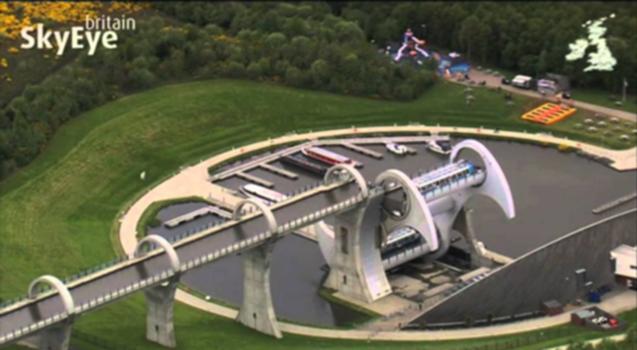 Falkirk Wheel : AS SEEN ON SKYEYE BRITAIN - LAUNCHING IN EARLY 2013! - www.skyeye-app.com
This is canal engineering brought bang up to date in a spectacular rotating boat lift. By the 1930s eleven locks, which joined the Forth and Clyde and Union Canals, had been filled in and built on. In a millennium project to link the two canals again the futuristic wheel won the competition, and was opened by Queen Elizabeth II in 2002.