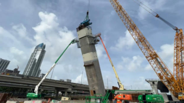 INSTALLATION OF ARCH SEGMENTS FOR THE I 395 SIGNATURE BRIDGE:Installation of a precast arch segments for one of the six arches that will part of the signature bridge. A total of 345 precast arch segments will be erected for the six arches.