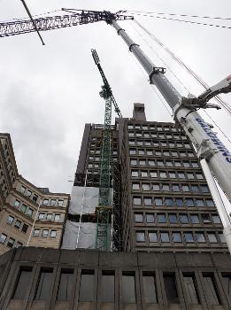 Just after erection of the (green) tower crane by a mobile crane for the demolition of 103 Colmore Row, Birmingham, England