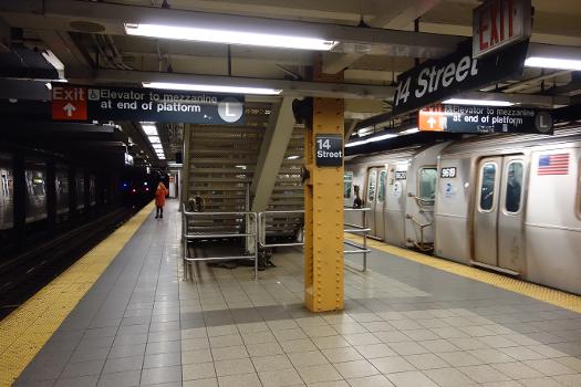 The Downtown platform of the 14th Street IND Eighth Avenue station in Chelsea / West Village, Manhattan : Unusual to IND stations, the platforms are supported only by a single row of columns. This layout is also seen at Canal Street farther south.