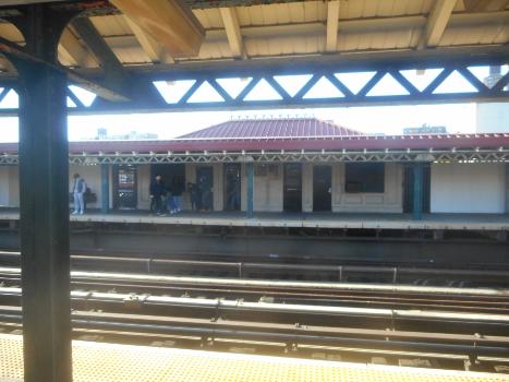 238th Street Subway Station (Broadway – Seventh Avenue Line):Looking west at the South Ferry -bound platform and station house from the Van Cortlandt Park-242nd Street-bound platform of the 238th Street Elevated Railway Station on the IRT Broadway – Seventh Avenue Line between the Riverdale and Kingsbridge sections of the West Bronx, New York City. No station house exists on the Van Cortlandt Park-bound platform.