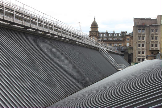 Queen Street station in Glasgow:The high curved span on the left covers the main platforms (numbers 2 to 6) while the sloping section is above the offices on the west side of the station.