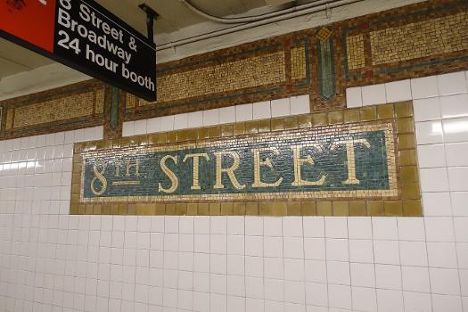 8th Street–New York University BMT Broadway station:A Dual Contracts mosaic at the south end of the Uptown platform of the 8th Street–New York University BMT Broadway station, under Broadway and Waverly Place in Greenwich Village / NoHo, Manhattan. Note the design connecting the mosaic with the border trim.