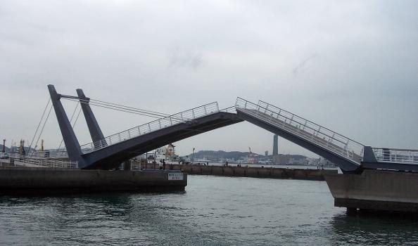 The Blue Wing Moji drawbridge is opening for boats : The bridge is open horizontally both left and right.