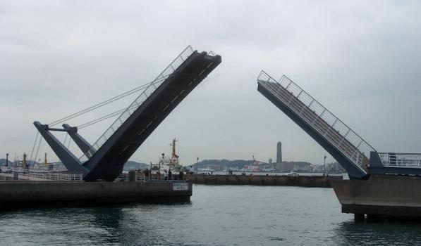 The Blue Wing Moji drawbridge is opening for boats:The bridge that raise up to the top.