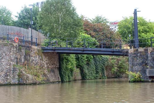 River Frome Footbridge:Entrance to the Castle Moat (of the long demolished Bristol Castle which stood to the left) viewed from the "Floating Harbour", the natural course of the River Avon, now diverted into an artificial channel to the south. Footbridge over. This was the site of the "Water Gate", guarded by five towers ("Bristol Past and Present")