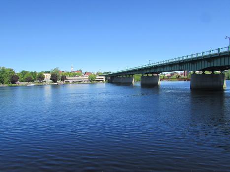 Chamberlain Bridge : This is the Chamberlain Bridge, one of three bridges spanning the Penobscot River between the cities of Bangor and Brewer in Penobscot County, Maine. This photo was taken from the Brewer waterfront. The skyline of Bangor is seen in the background.