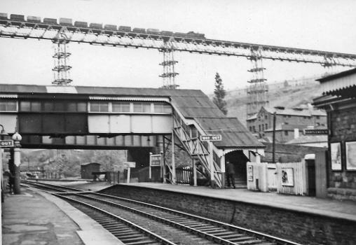 Crumlin (Low Level) station and Crumlin Viaduct : View NE, towards Aberbeeg and Ebbw Vale/Brynmawr on the ex-GW Newport - Western Valleys lines. The station and both lines closed to passengers from 30/4/62. Freight ceased on the Ebbw Fach line in 1975, but has continued to Ebbw Vale. On the restored passenger service to Ebbw Vale, commencing on 6/2/08, the nearest station is Newbridge. High up on the celebrated viaduct of the ex-GW Neath - Pontypool Road line, just east of Crumlin (High Level), is an eastbound coal train - looking very perilous.