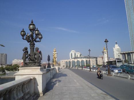A European style bridge in Tianjin : The European figures hold Chinese musical instruments