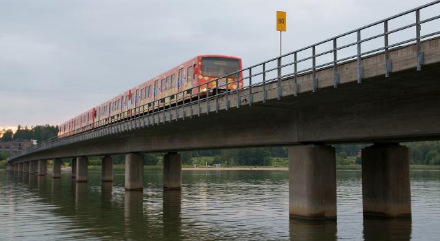 A Helsinki metro train crossing the Vuosaari metro bridge, between the stations of Rastila and Puotila