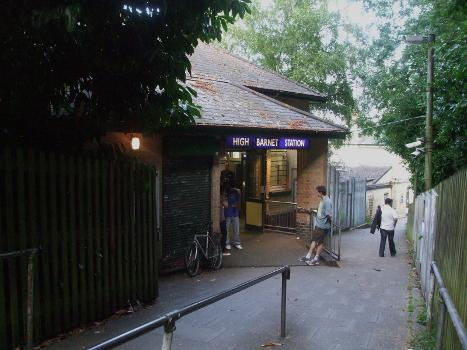 High Barnet tube station entrance:The old Great Northern Railway building can be seen in the background at the bottom of the footpath