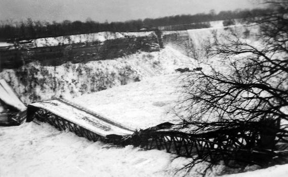 The collapsed Honeymoon Bridge at Niagara Falls : The bridge rests on an ice jam in the Niagara River, Winter 1938 (viewed from Canadian side).