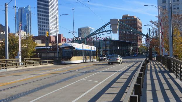 Hop streetcar westbound on the St. Paul Avenue Bridge, over the Milwaukee River