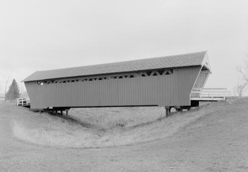Northwestern side of the Imes Covered Bridge : The bridge spans a small ravine near Iowa Highway 251 in the vicinity of St. Charles, Iowa. Built in 1870, this covered bridge (the oldest remaining in the county) is listed on the National Register of Historic Places.