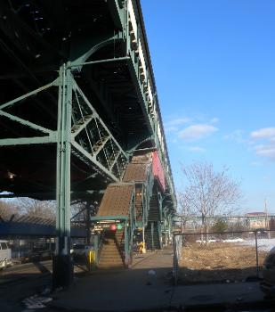 Looking east at southwest stair of Junius St station on a sunny afternoon