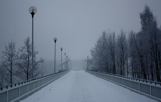 Pedestrian and bicycle bridge Korkeasaarensilta in fog in Oulu