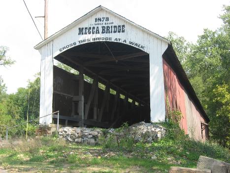 Moscow Covered Bridge : Western portal and southern side of the Mecca Covered Bridge, which spans Big Raccoon Creek next to Wabash Street in Mecca, Indiana, United States. Built in 1873, it is listed on the National Register of Historic Places.