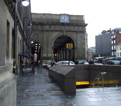 Newcastle Central Station:The view west over the Neville Street entrance to Central Station station on the Tyne and Wear Metro and along the front of the mainline station building, to ist portico.